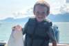 young boy holding halibut catch