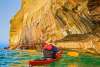 Image of a person paddling a kayak at Pictured Rocks National Lakeshore, located in Michigan's Upper Peninsula, USA