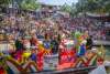 View of river barge floating by large group of people