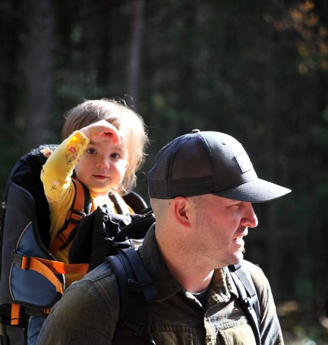 Dad hiking with baby in backpack carrier