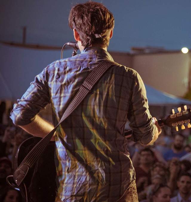 Guitar Player in front of crowd at outdoor event