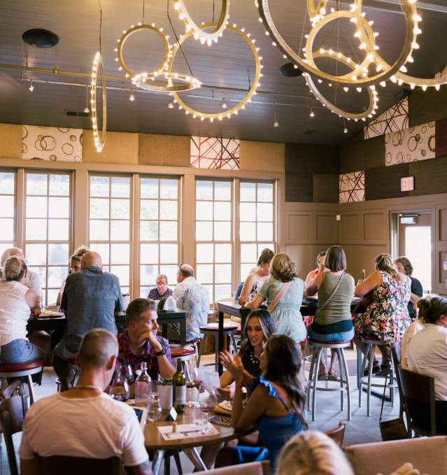 Patrons of Aubrey Vineyards taste wine and snack on charcuterie.