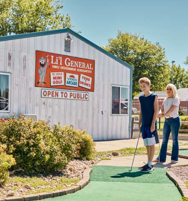Family playing mini golf