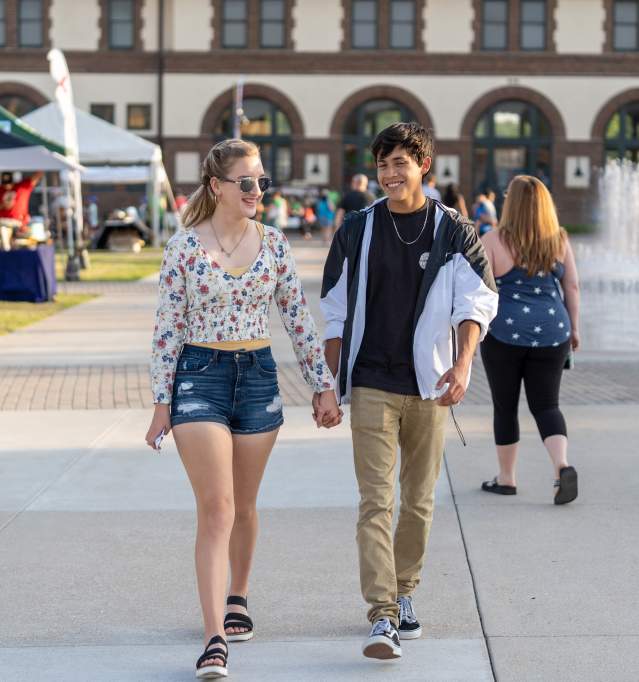 Couple walking along the fountain path at Santa Fe Plaza