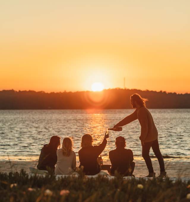 Group enjoying sunset over a lake in Dwellingup