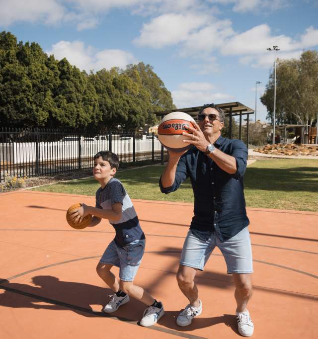 Son and Dad throwing basketball
