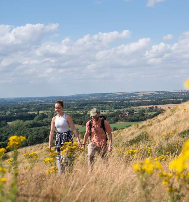 two people walking up a hillside in the Lincolnshire Wolds