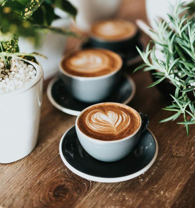 A coffee cup with latte art on a table
