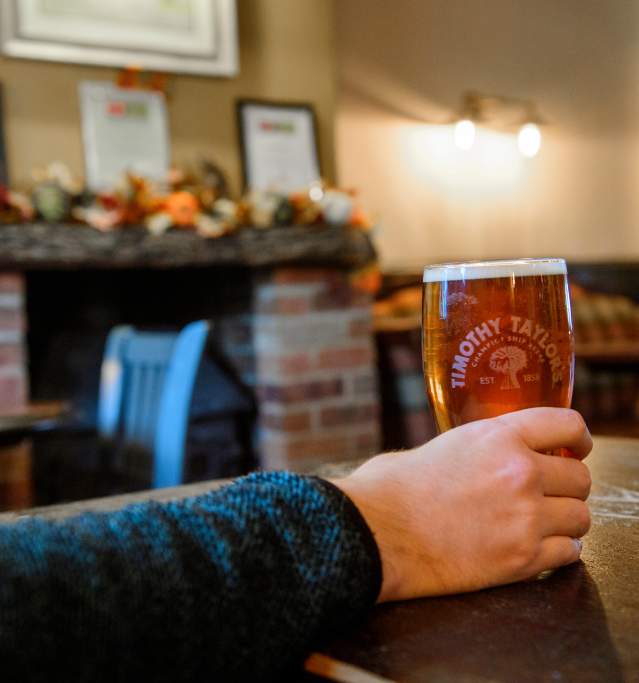 A man holding a pint of beer at a pub in the Lincolnshire Wolds