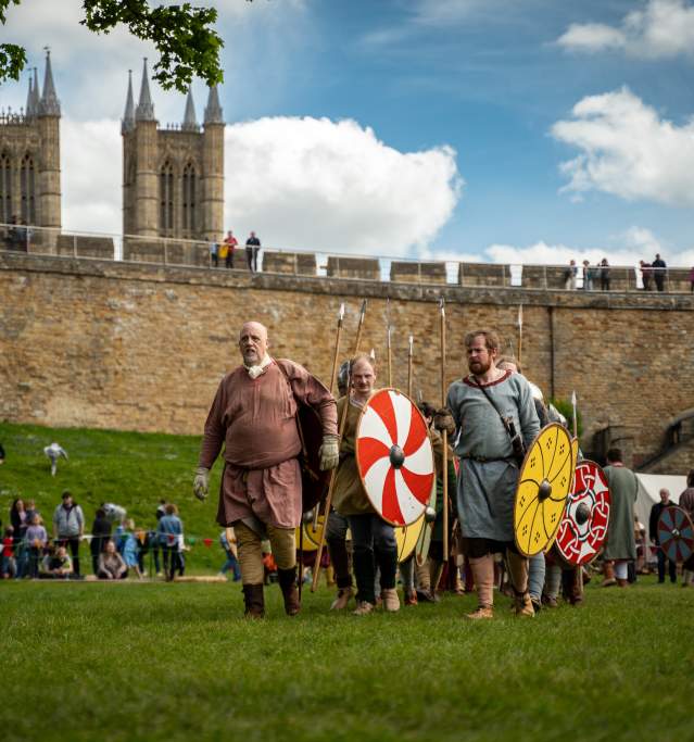 A group of people re-enacting historic battles and life