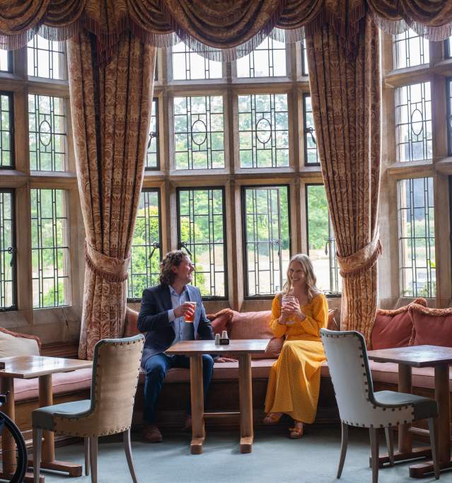 Two people enjoying a beverage inside the petwood hotel