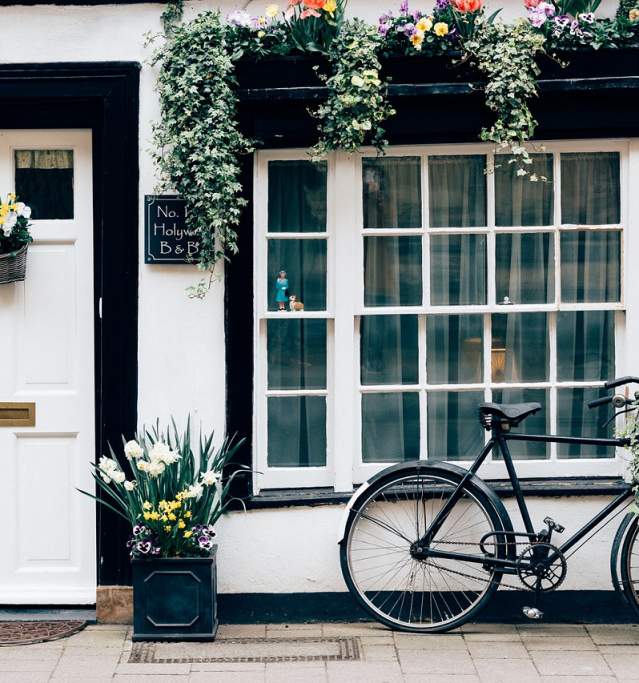 a B&B in Horncastle with white walls and a bike with with planter at the door