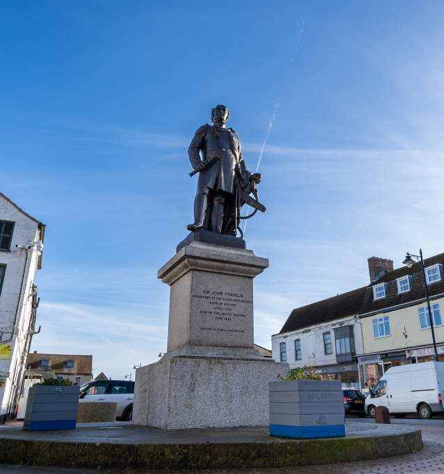a statue of Sir John Franklin in Spilsby town under blue skies