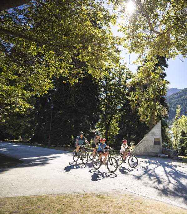 A family biking in the Queenstown Gardens