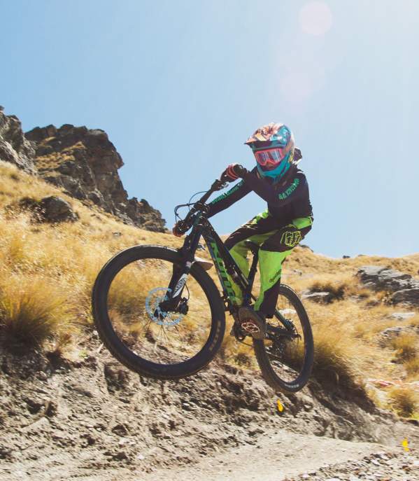 Young kid mountain biking down dirt tracks