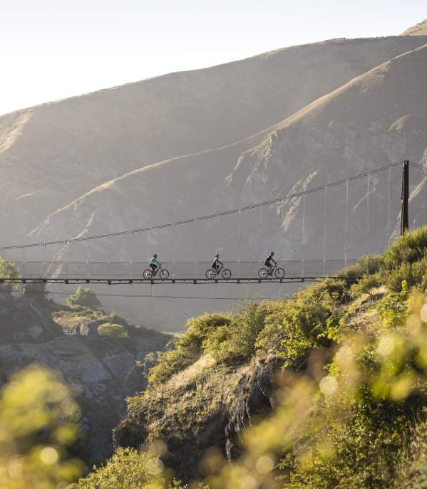 Group of three biking across Edgar Bridge