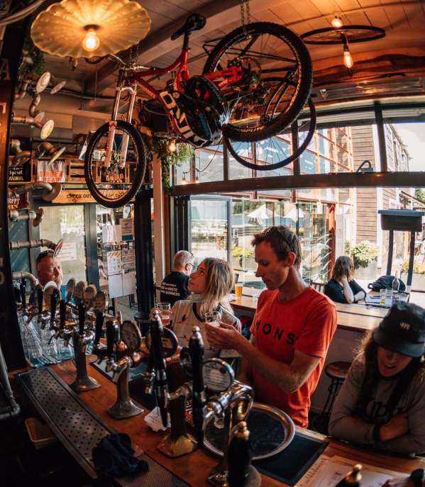 Mountain bikers ordering a drink at Atlas Beer Cafè