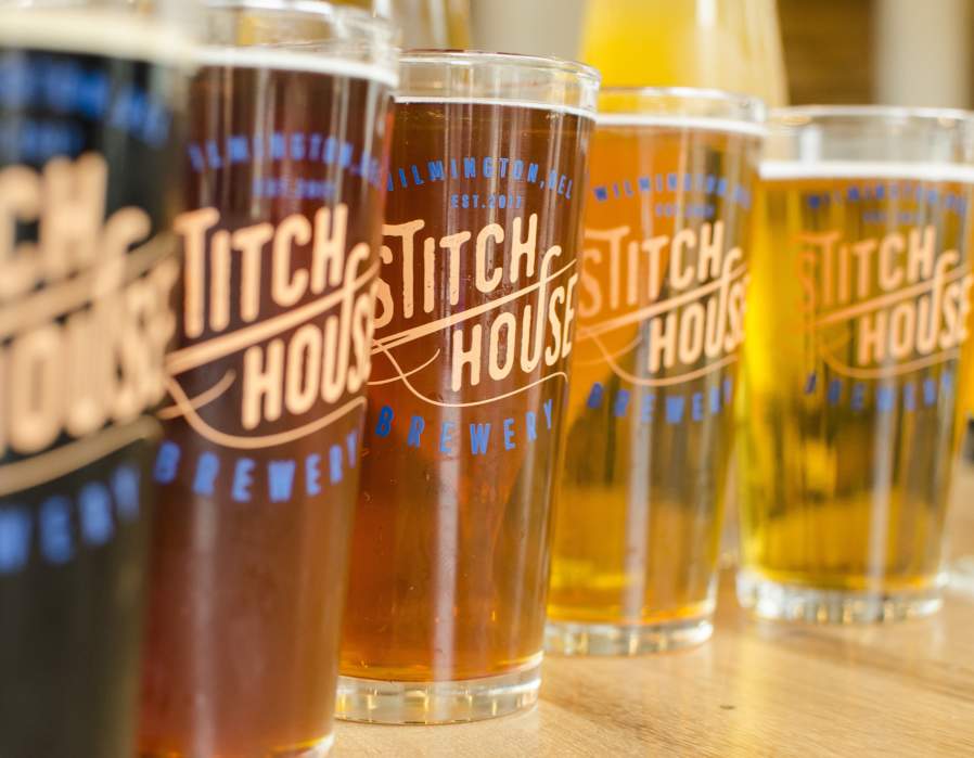 Stitch House Brewery beers in assorted amber and golden hues.