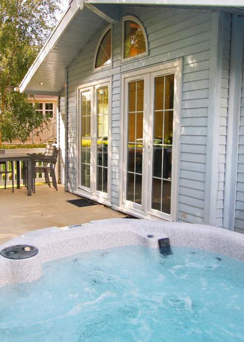 Chalet with outdoor hot tub at Shorefield Holiday Park in the New Forest