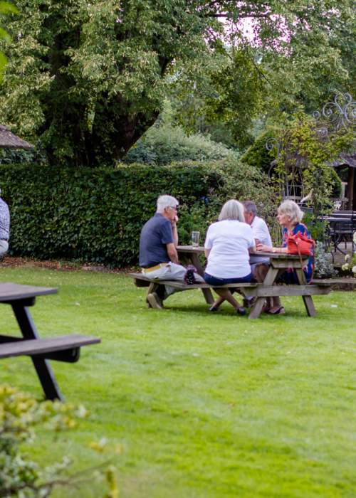 People sitting in pub garden at The Bell Inn in the New Forest