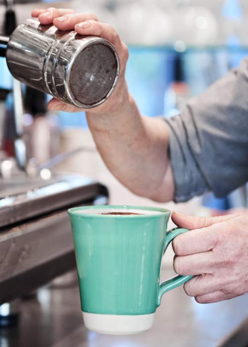 Barista making coffee at cafe in the New Forest