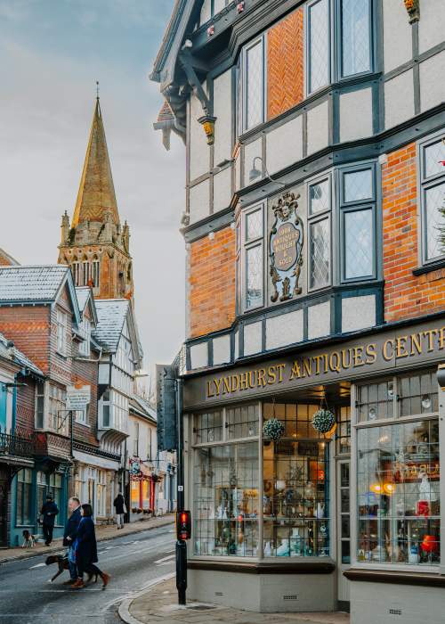 People walking on Lyndhurst high street outside the Antiques Shop in the New Forest