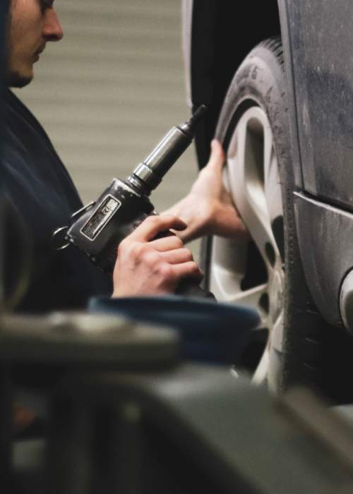 mechanic fixing tyres on car