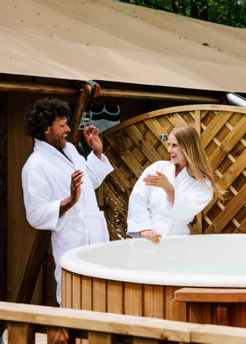Couple playing by the hot tub at holiday park in the New Forest