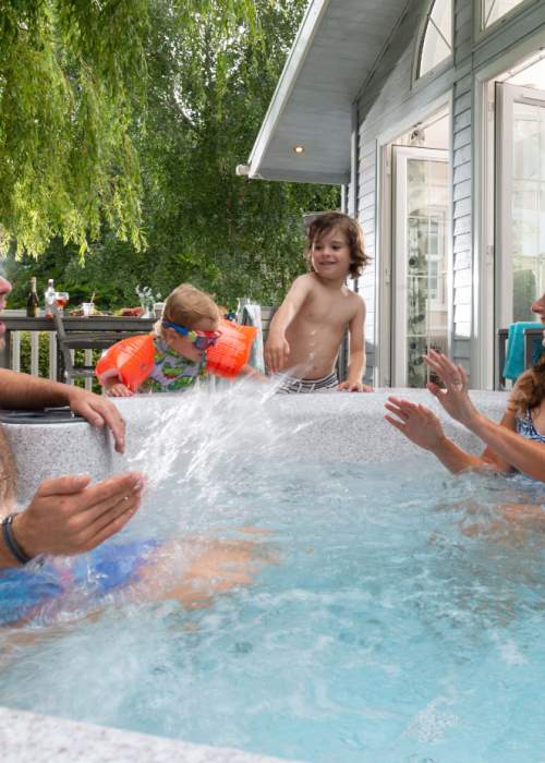 Family in hot tub at lodge at holiday park in the New Forest