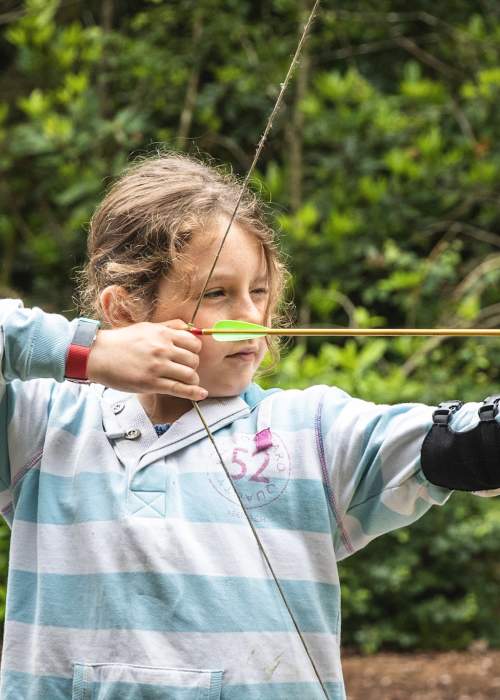Girl doing archery at New Forest Activities - Activities Hero