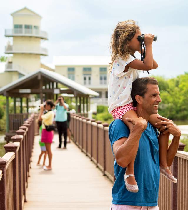 Family exploring the Birding Center boardwalk and birdwatching