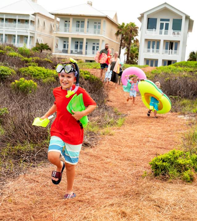 Family walking down beach path