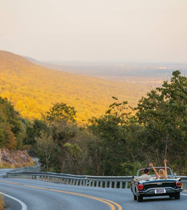 Couple driving in a convertible car along Waggoner's Gap