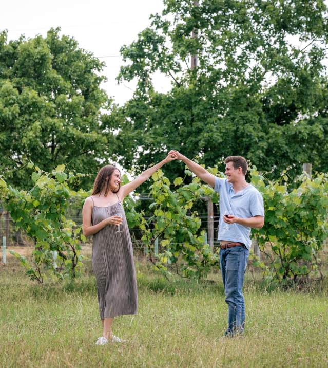 Couple dancing in front of grape vines at Totem Pole Ranch & Winery