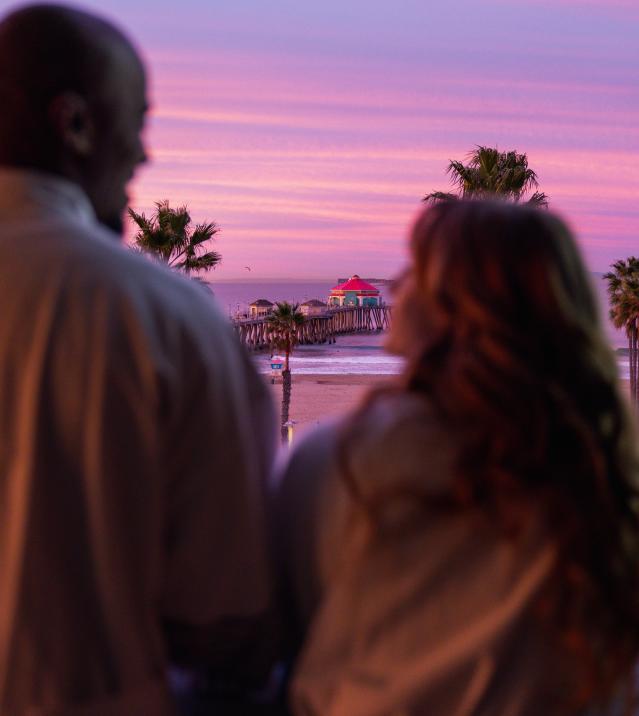 Couple on the balcony at sunrise Huntington Beach in Kimpton Shorebreak Resort
