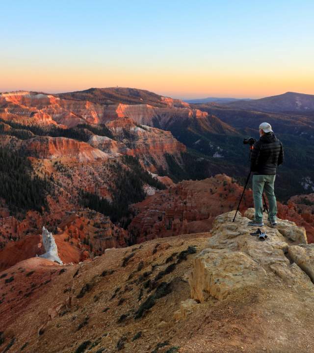 man filming on a rock