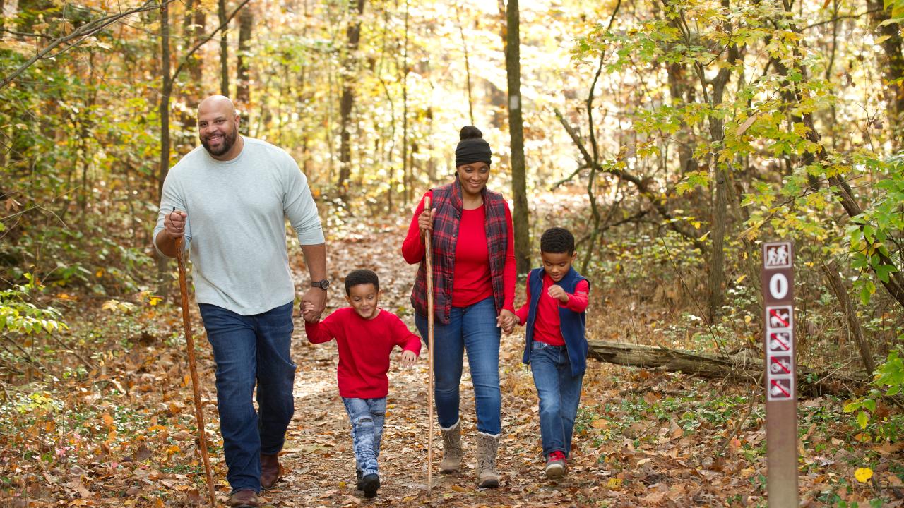 Family hiking Deam Lake Knobstone Trail in the fall