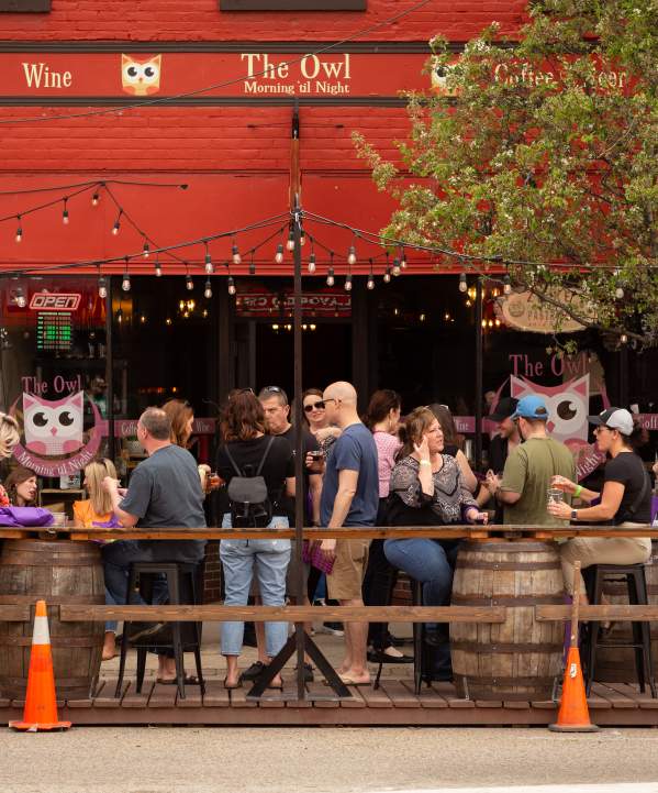 People dining outdoors at The Owl in Milan, MI