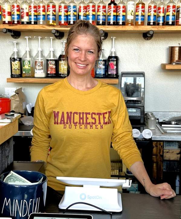 Owner stands behind counter at Millie's coffeehouse in manchester MI