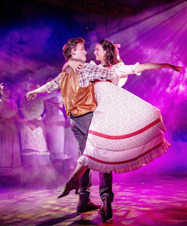 Man and woman dancing on stage during a production of Oklahoma