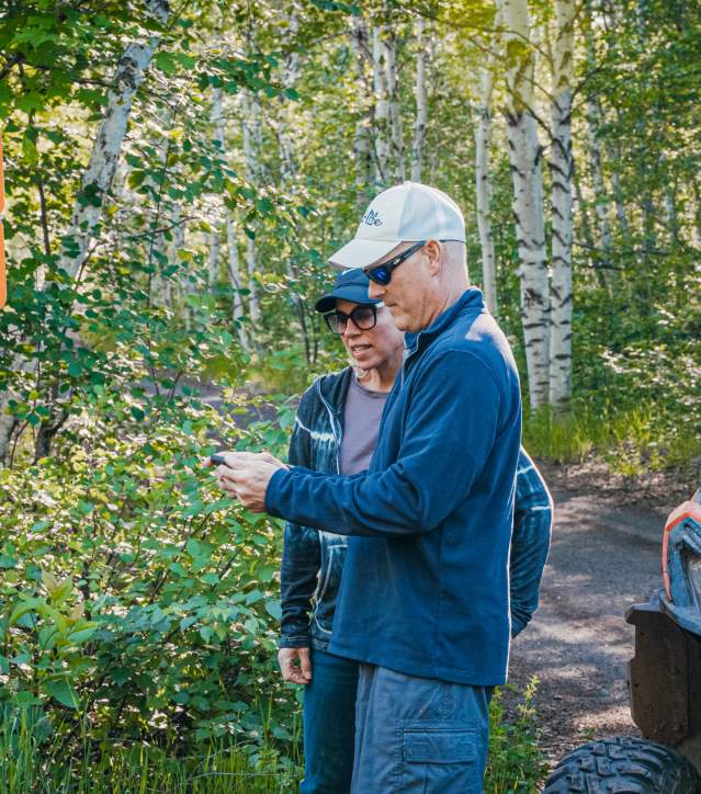 Two people use their phone to plan their route.