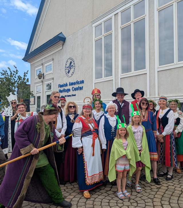 a large group of people pose in traditional cultural clothing and costumes of legendary tales