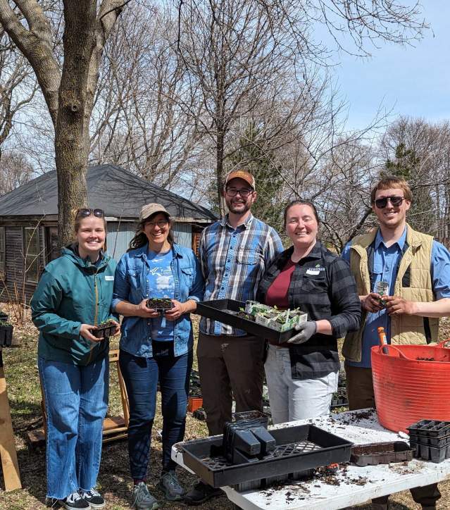 Visit Keweenaw staff takes a photo at the Keweenaw Land Trust native plant event.
