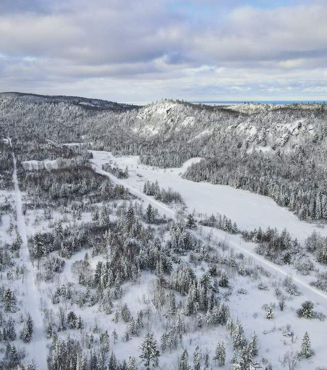 Winter Aerial with Trees, Trails, and Mountains