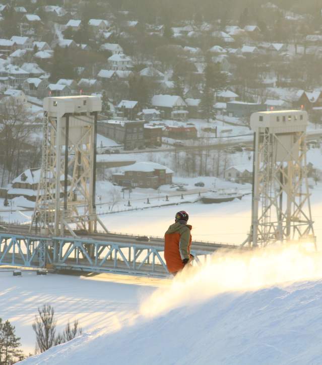 Mont Ripley Skier with Portage Lake Lift bridge in backgroud.