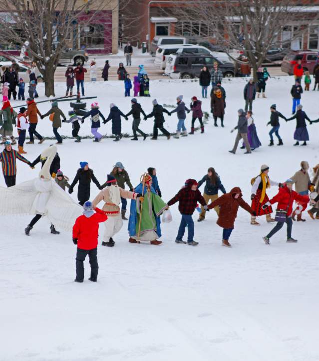 people dance in a spiral