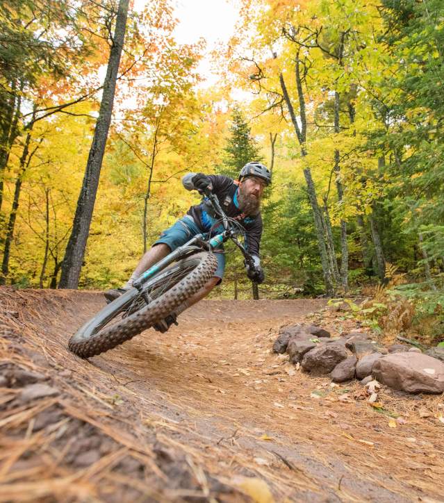 A biker cruises down a Copper Harbor mountain biking trail.