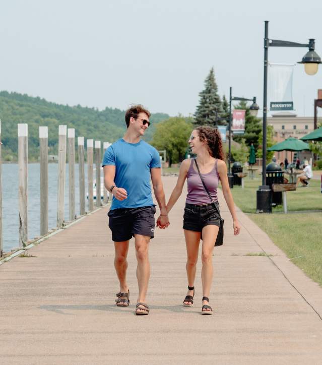 A couple walks along the waterfront trail in Houghton