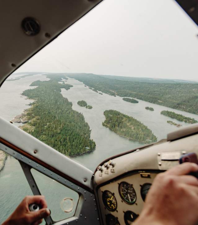 Pilot in seaplane overlooking islands