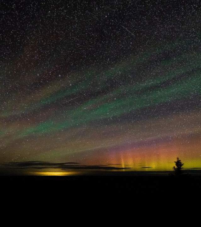 A touch of Aurora Borealis Colors and countless stars dot the night sky